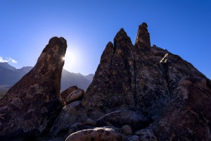 Photo of a sunburst behind a rock at Movie Flats, Lone Pine, California, by visionbypixels.com