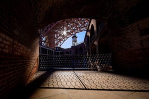 Photo of the sun setting behind the Golden Gate Bridge at Fort Point, San Francisco, California by visionbypixels.com